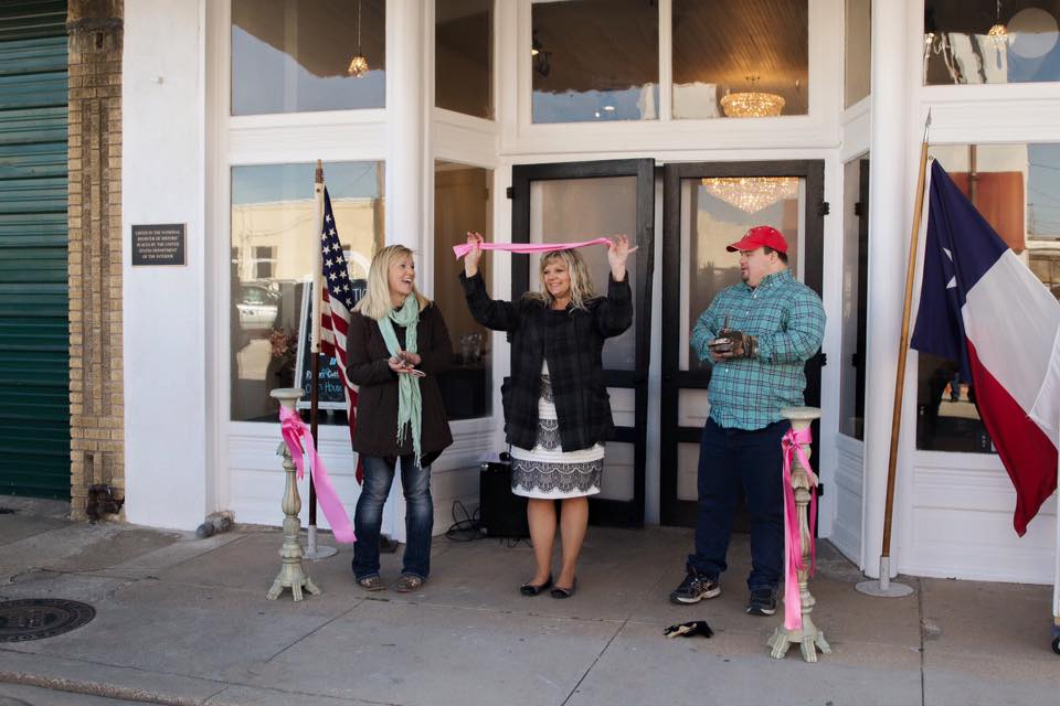 Tirzah Ribbon Cutting Ceremony - Diana Cory Candice - Holding up the Ribbon
